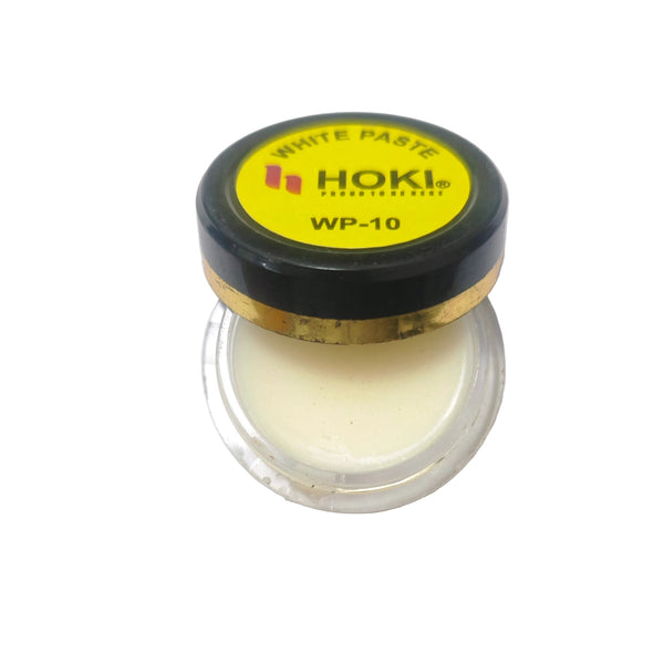 Jar of white paste with HOKI branding on a white background