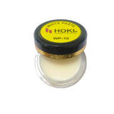 Jar of white paste with HOKI branding on a white background